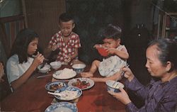 Family Dinner - A Grandmother, Mother, and Two Young Children Enjoy Dinner Together Postcard