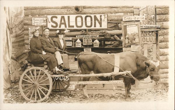 Family gets picture taken on a cart in front of Saloon Sign Hot Springs Arkansas