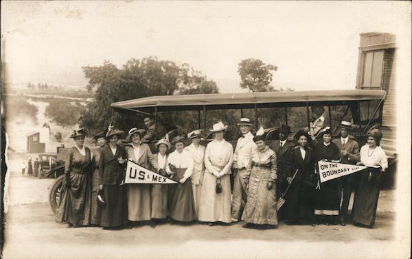 Men and women pose while touring the U.S. / Mexico border