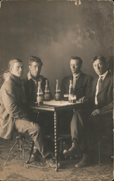 Four Men in Suits and Jackets Drinking Beer Studio Photos