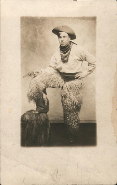Young Man Dressed as Cowboy Wooly Chaps Holding a Pistol