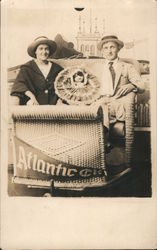 Man and Woman in rolling chair, Studio Photo Postcard