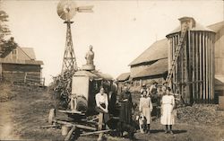 Farming family posed with equipment Postcard