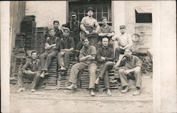 Workers sitting on pallets Postcard
