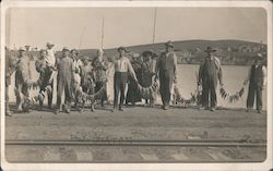 Fishermen holding fish on lines Postcard