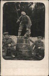 Group of Soldiers Clowning Around in a Barrel Postcard
