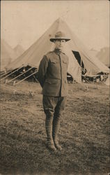 a soldier standing in front of a tent Army Postcard Postcard Postcard