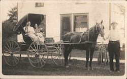 Two women sit in a small covered horse-drawn buggy, a man holds the horse's harness Wabash, IN Postcard Postcard Postcard