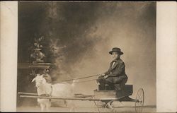 Boy in Hat and Suit Sits in Cart Harnessed to a Goat Postcard