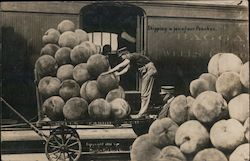 Shipping a few of our Peaches, a train worker loads huge peaches onto a train Postcard