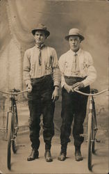 Two men posing with bicycles. Postcard Postcard Postcard