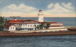 The Lighthouse, "on the Ocean" - A hotel on a pier with a large lighthouse Postcard