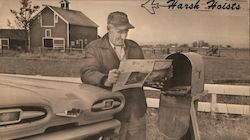 Harsh Hoists - A farmer is leaning on a car and reading a newspaper. Postcard