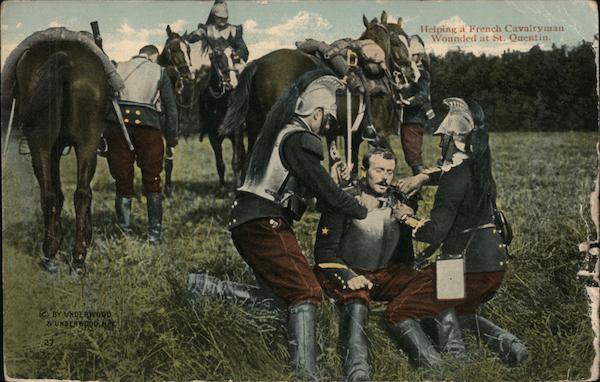 Helping a French Cavalryman wounded at St. Quentin  (WWI card sent during WWII)