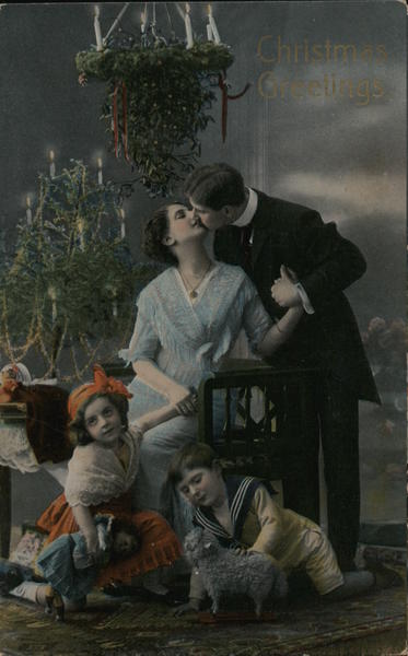 Christmas Greetings - Portrait of Mother and Father Kissing with Children (boy and girl) Playing on the Floor