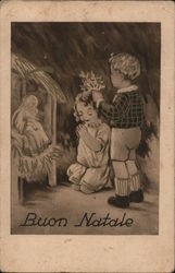 Buon Natale - Two children kneel before a manger scene Postcard