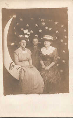RPPC 3 People Seated Left Facing Paper Moon Stars Behind Women Man Antique VTG